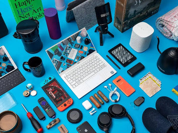 Collection of electronic devices and accessories on a blue background